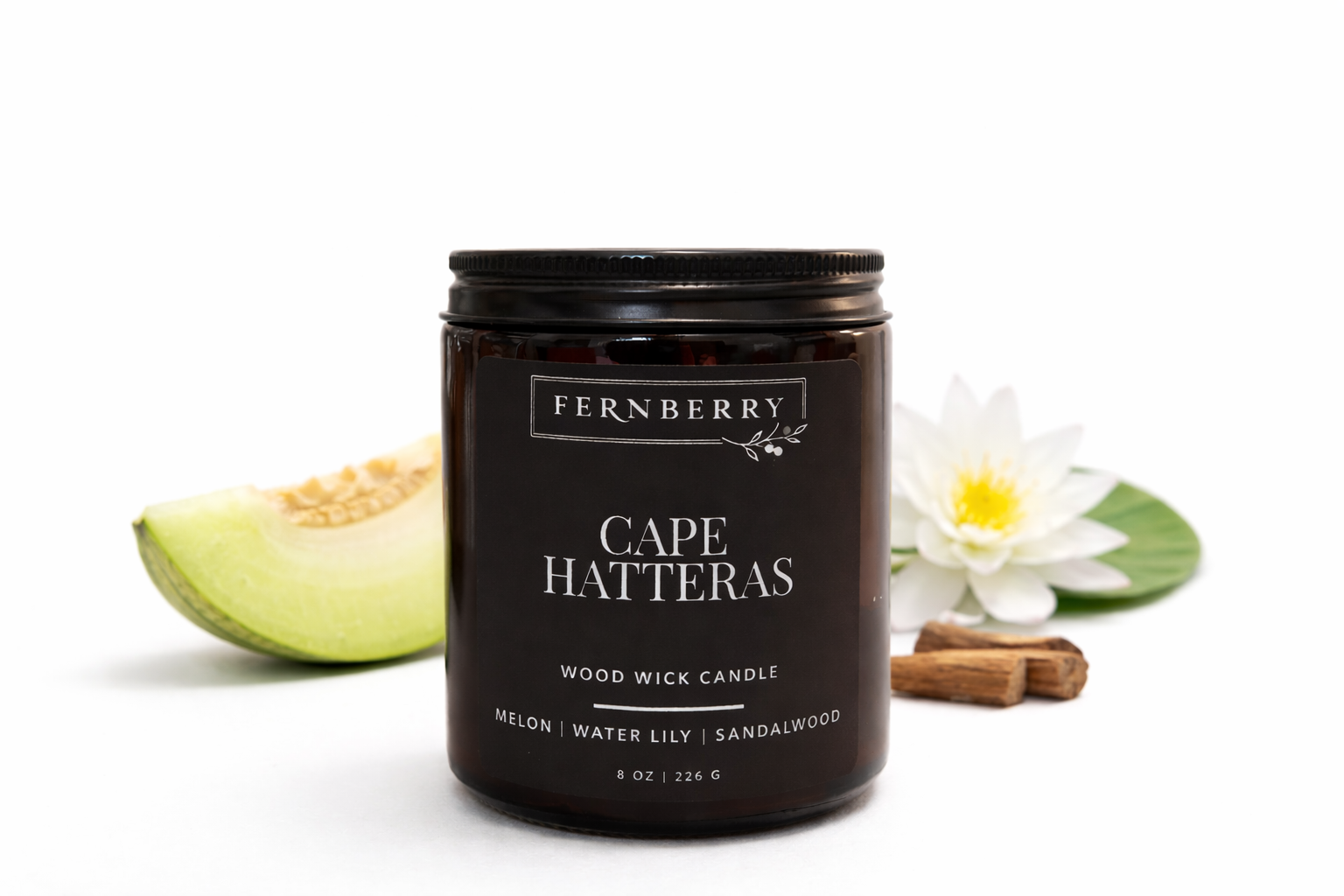 Fernberry Cape Hatteras candle with melon, water lily, and sandalwood elements on a white background