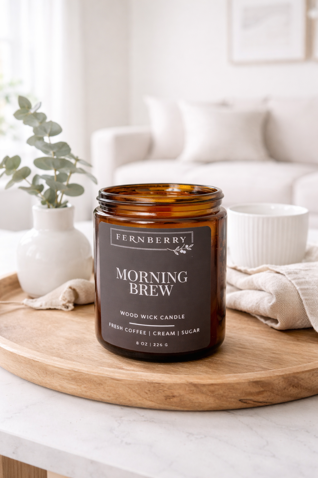 Fernberry Morning Brew candle on a wooden tray in a home setting