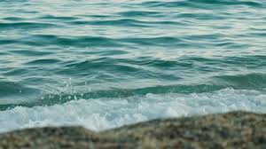 Close-up of ocean waves crashing onto a rocky shore