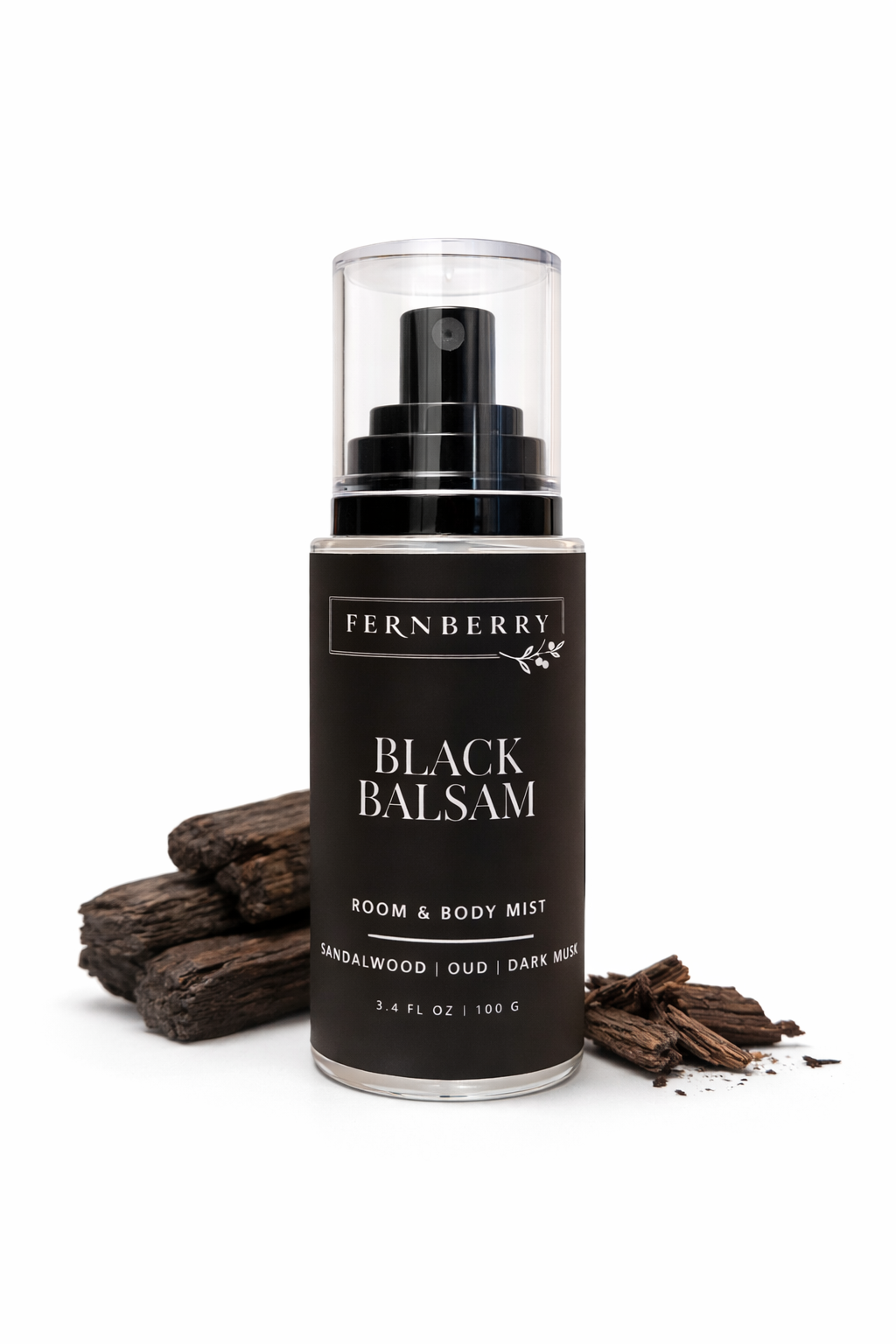 Fernberry Black Balsam room & body mist with wooden elements on a white background