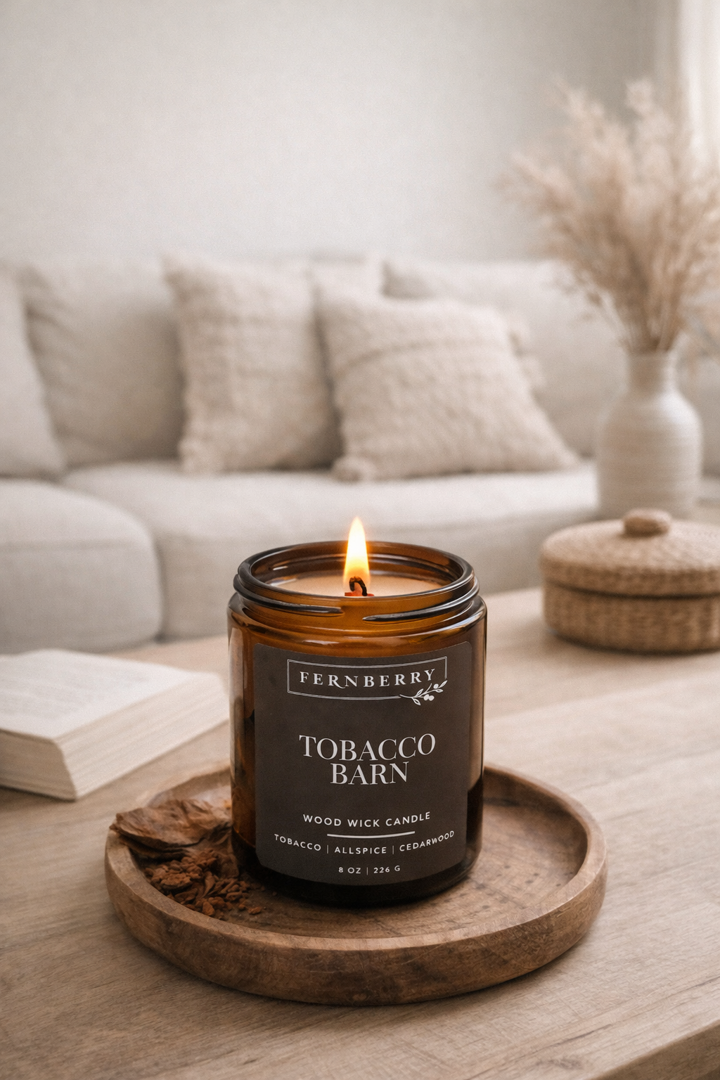 Fernberry Tobacco Barn candle on a wooden tray with a blurred background