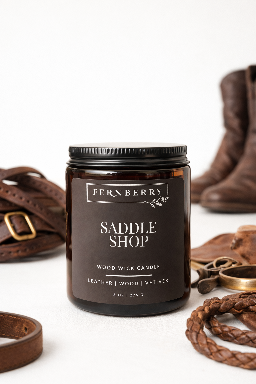 Fernberry Saddle Shop candle with leather accessories on a white background