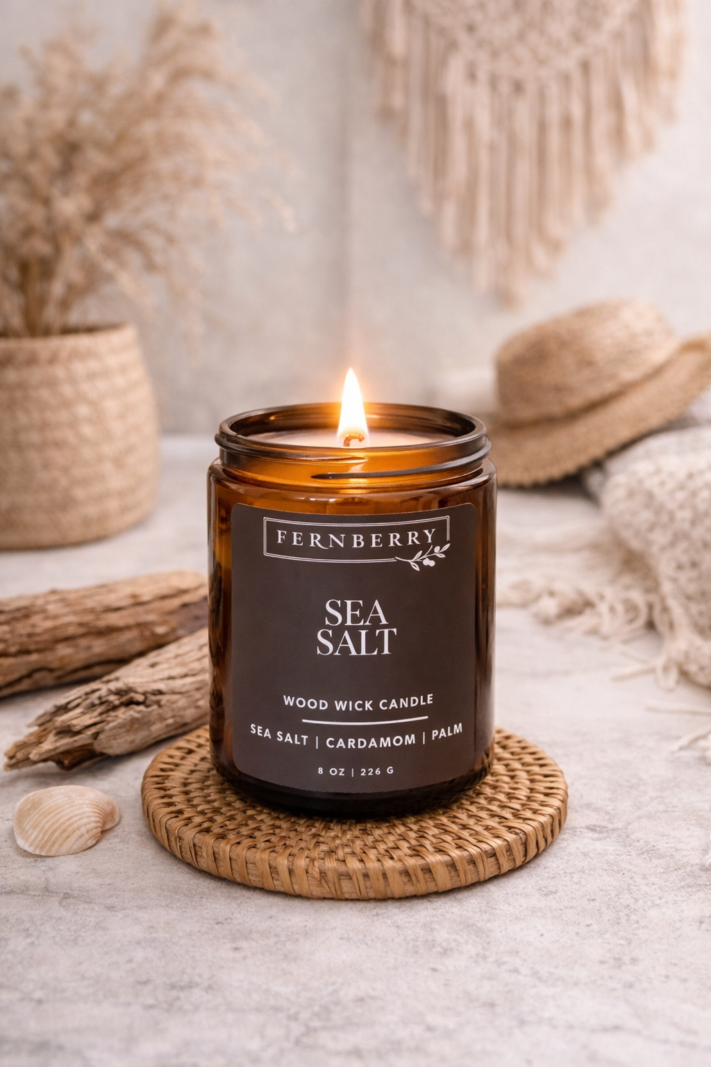 Fernberry Sea Salt candle on a woven coaster with natural elements in the background